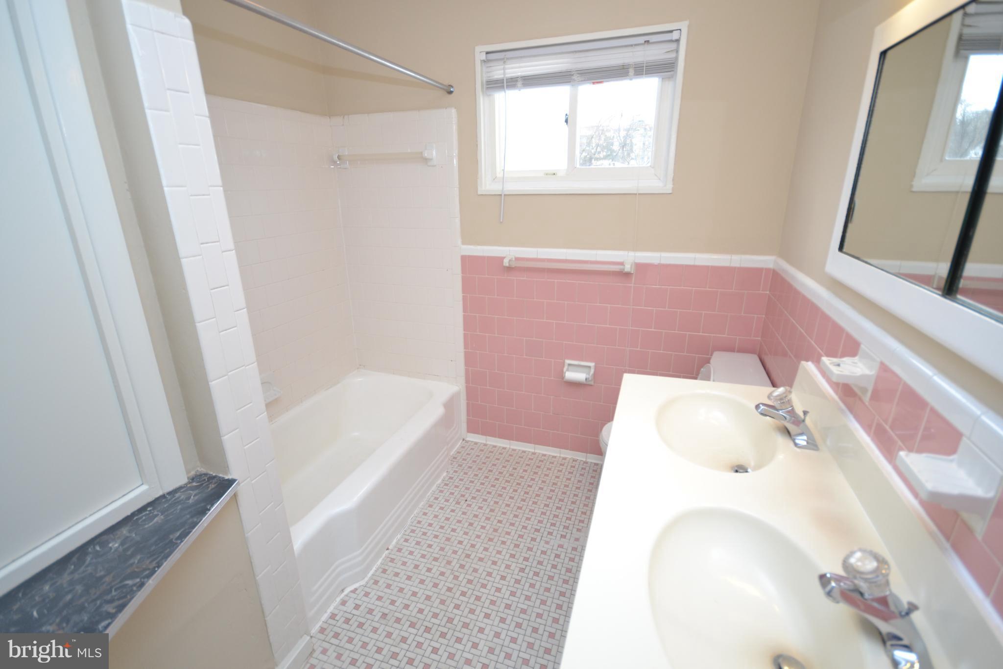 7122 Boxford Road Baltimore, MD 21215 - Photo 11 of 14 a bathroom with a bathtub and a shower