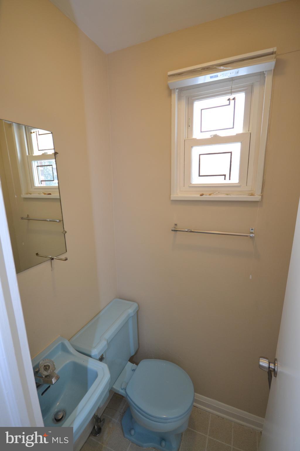 7122 Boxford Road Baltimore, MD 21215 - Photo 7 of 14 a white toilet sitting next to a window