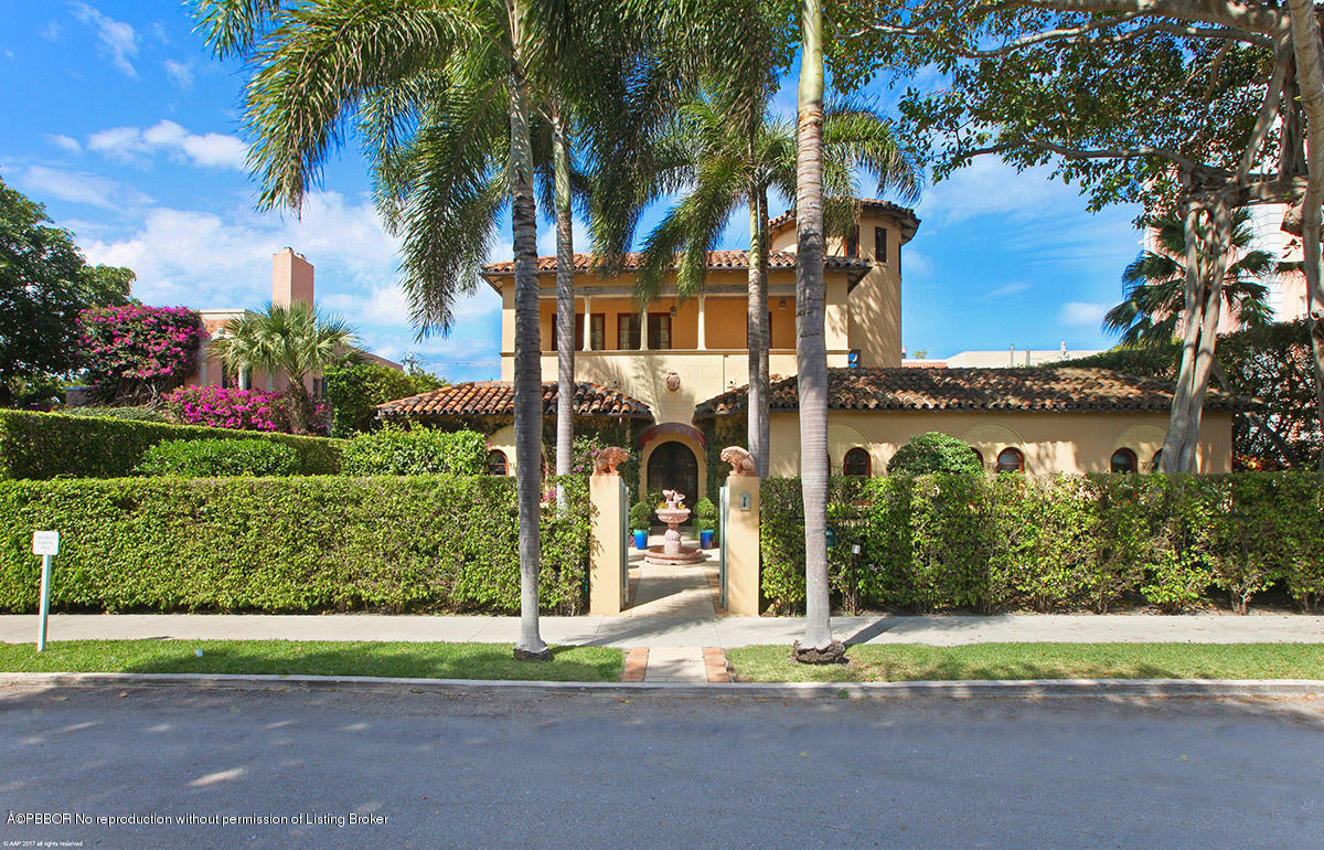 1 Golfview Road Palm Beach, FL 33480 - Photo 1 of 38 a front view of a house with a yard and potted plants