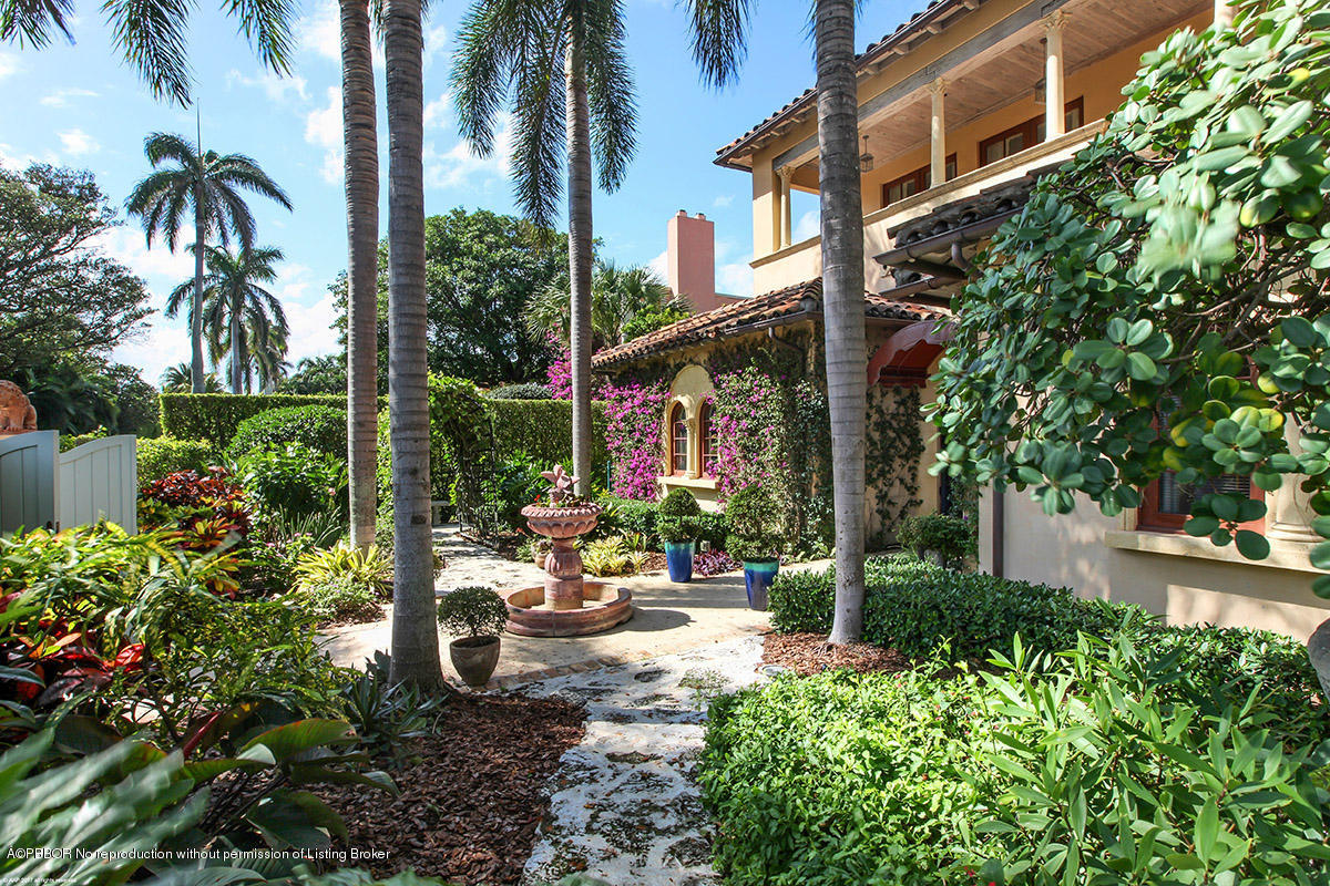 1 Golfview Road Palm Beach, FL 33480 - Photo 29 of 38 a view of a patio with table and chairs potted plants and palm trees