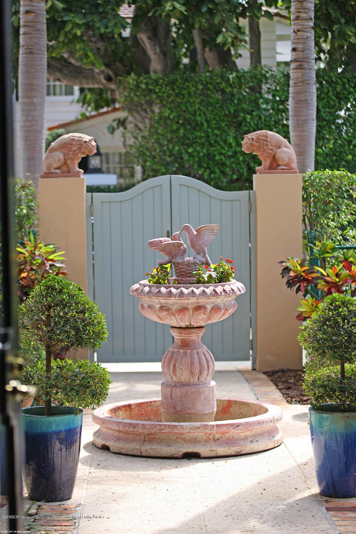 1 Golfview Road Palm Beach, FL 33480 - Photo 32 of 38 a view of a fountain in the patio with potted plants