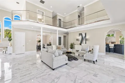 a kitchen with stainless steel appliances granite countertop a stove top oven a sink dishwasher a dining table and chairs with wooden floor