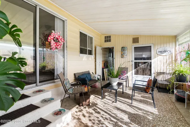 a living room with furniture and flowers