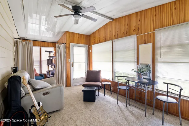 a view of a dining room with furniture a chandelier and wooden floor