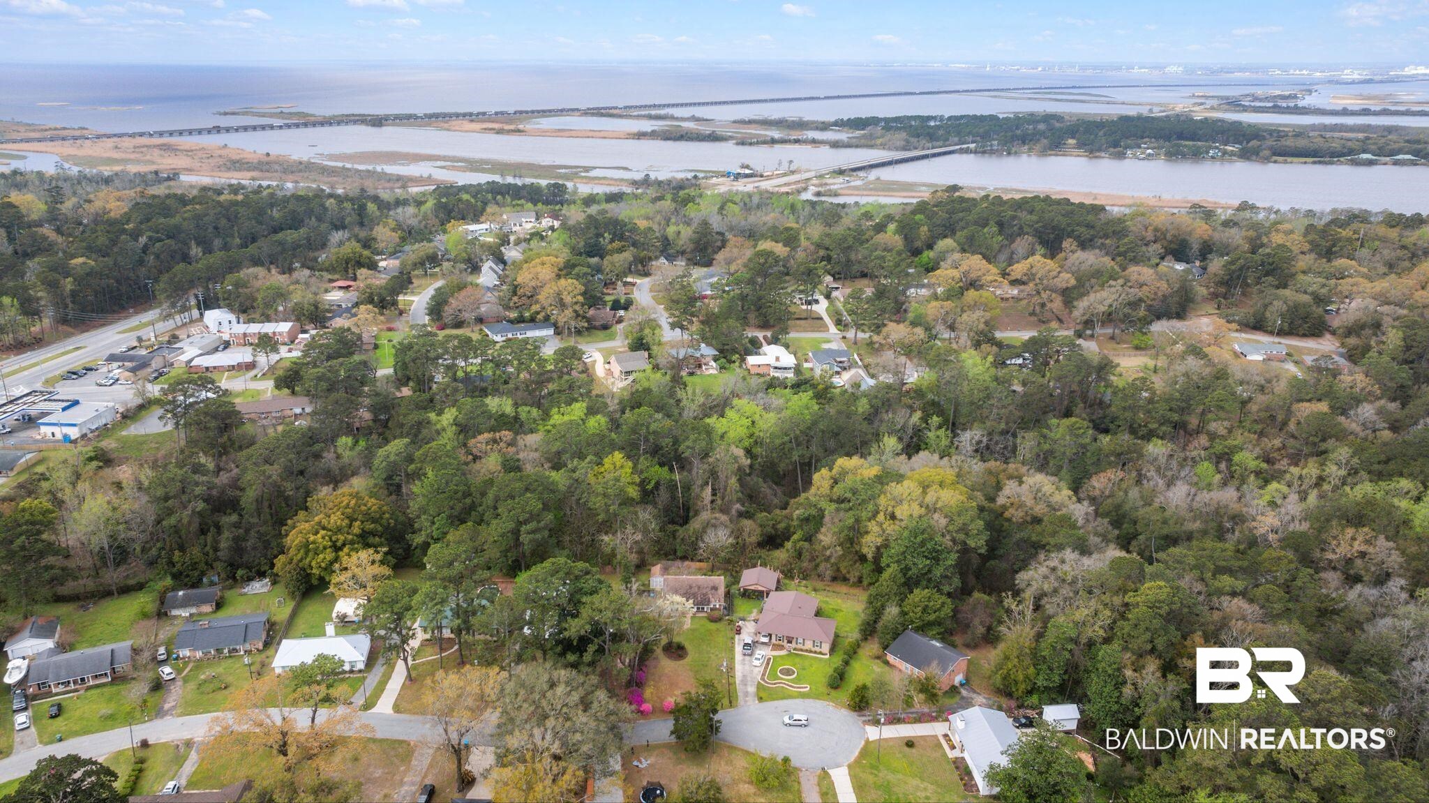 18 Lee Circle Spanish Fort, AL 36527 - Photo 39 of 50 Aerial view of property and surrounding area featuring nearby suburban area, a large body of water, and a notable bridge