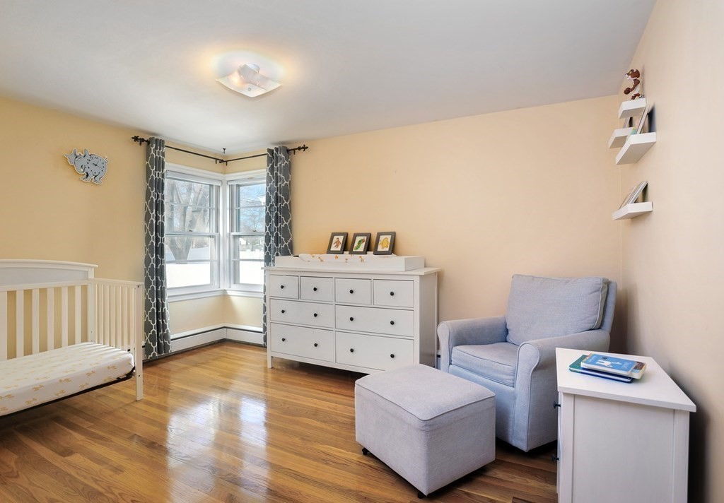 7 Spring Street Weymouth, MA 02188 - Photo 11 of 18 a bedroom with furniture and a wooden floor