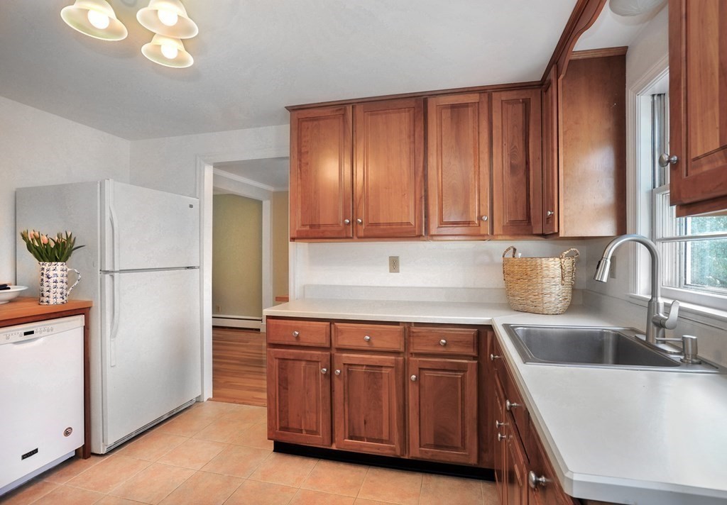 7 Spring Street Weymouth, MA 02188 - Photo 9 of 18 a kitchen with a sink cabinets and stainless steel appliances