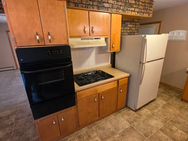 a kitchen with a refrigerator and a stove