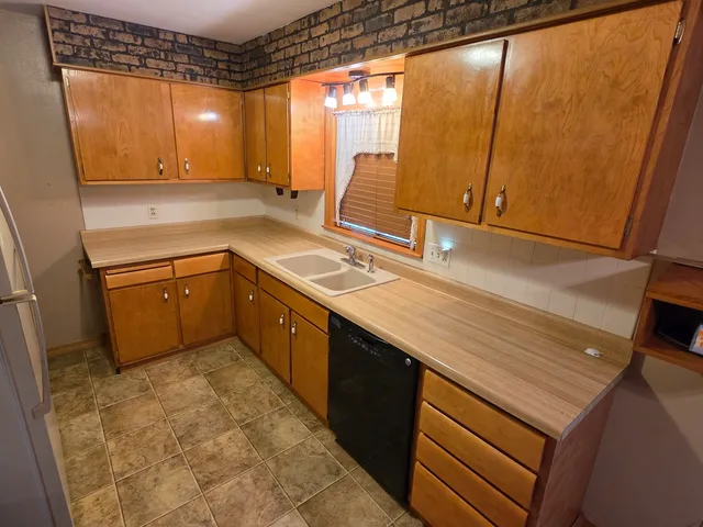 a kitchen with a sink a stove and cabinets