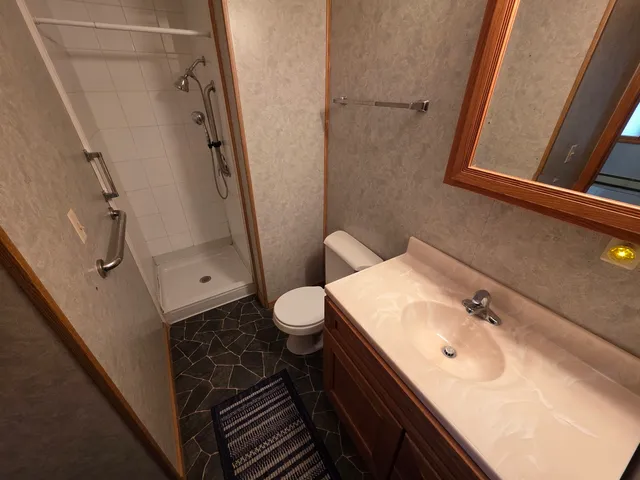 a view of a livingroom with a ceiling fan and window