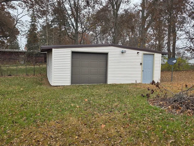 a backyard of a house with a yard and garage