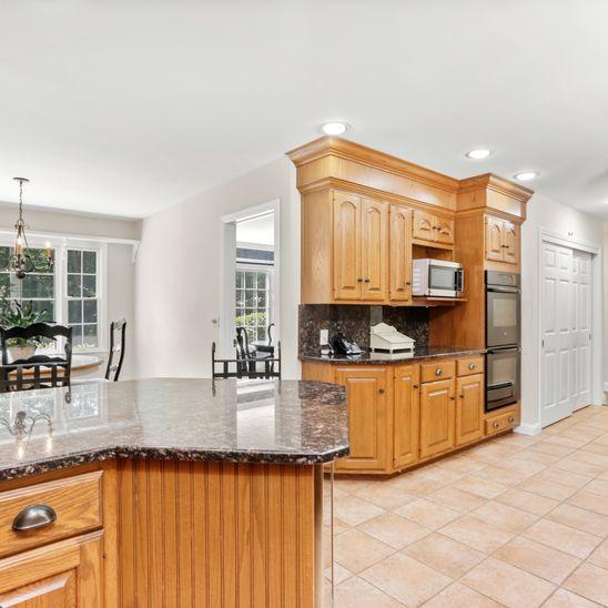 46 Musket Ridge Road Wilton, CT 06897 - Photo 8 of 35 a kitchen with stainless steel appliances granite countertop a sink and cabinets