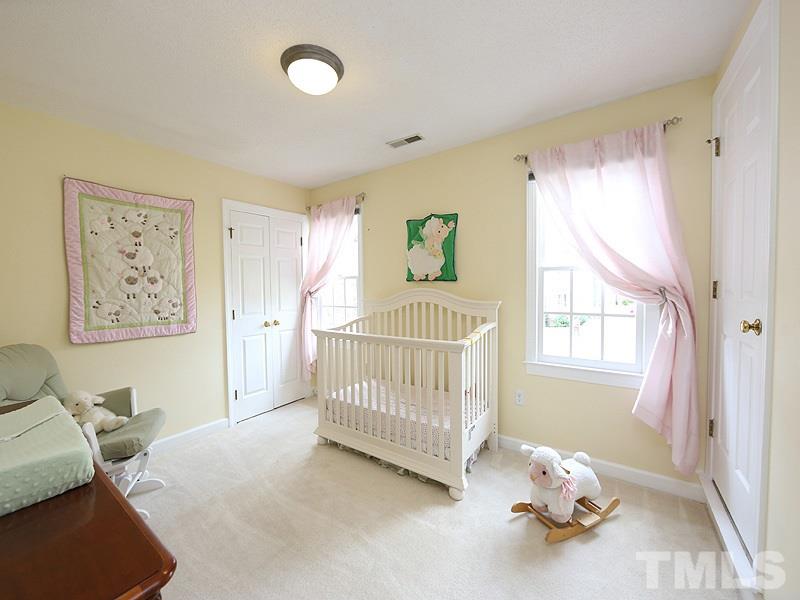 6 Striding Ridge Court Durham, NC 27713 - Photo 14 of 25 a bedroom with a bed and a window