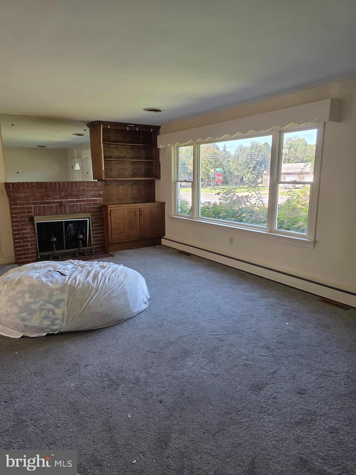 706 East Division Street Dover, DE 19901 - Photo 12 of 16 an empty room with furniture fireplace and windows