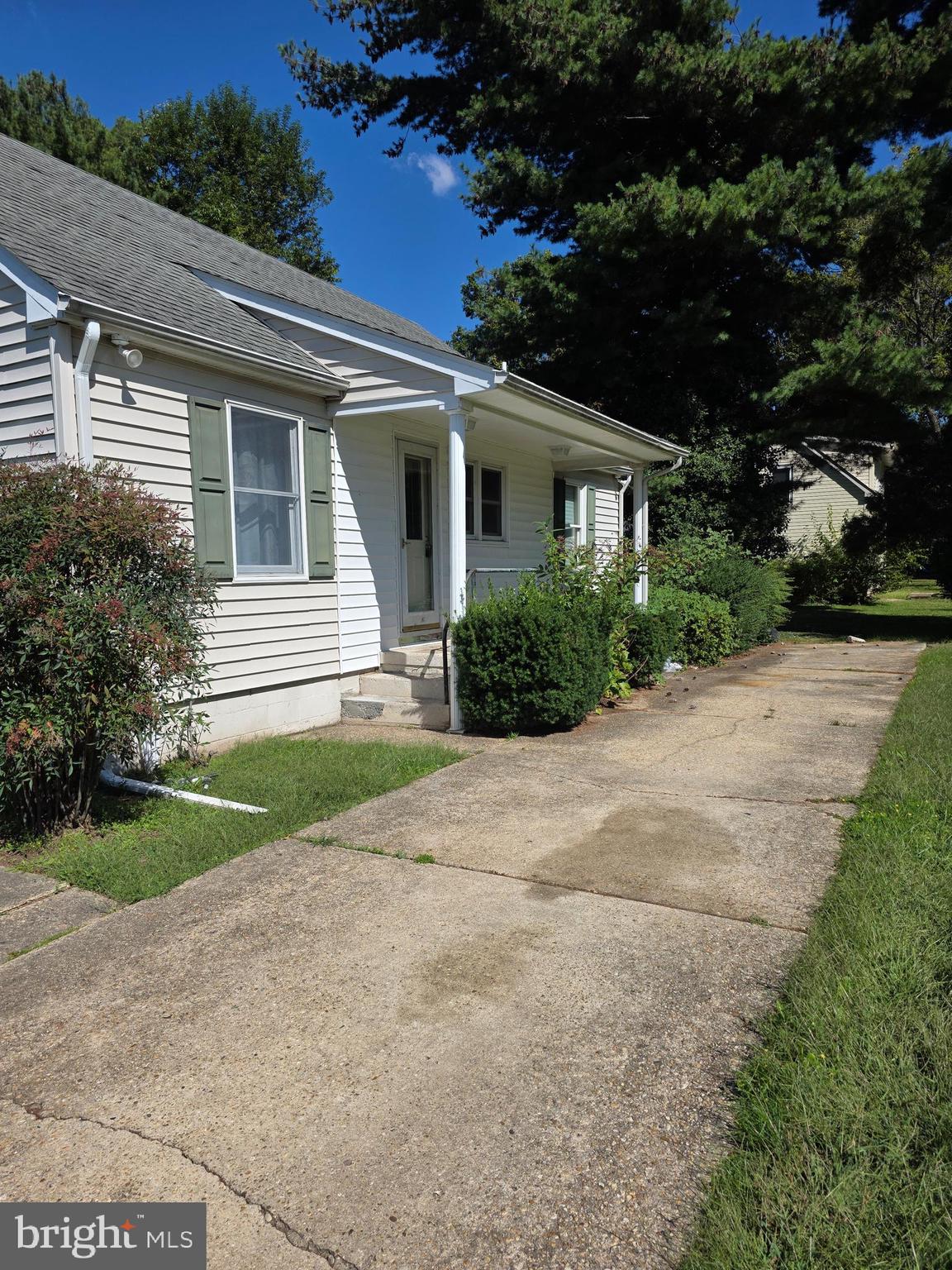 706 East Division Street Dover, DE 19901 - Photo 3 of 16 a view of house in front of a yard with potted plants