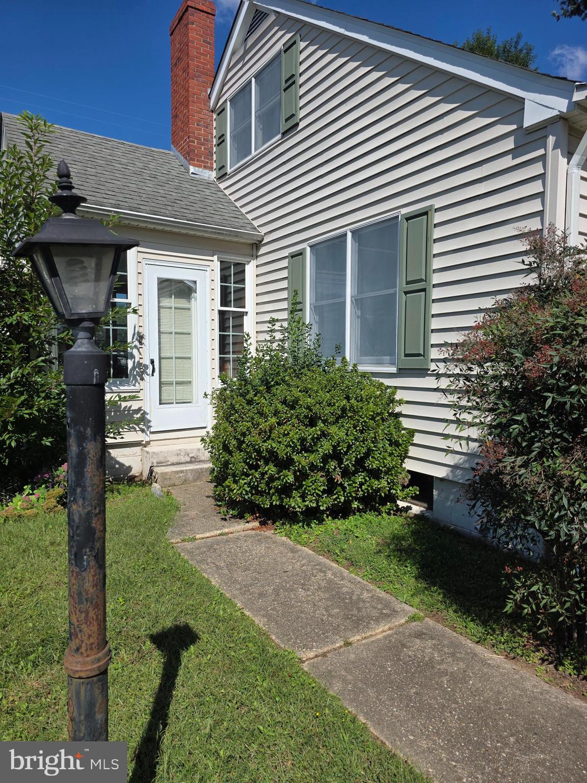 706 East Division Street Dover, DE 19901 - Photo 4 of 16 a front view of a house with garden