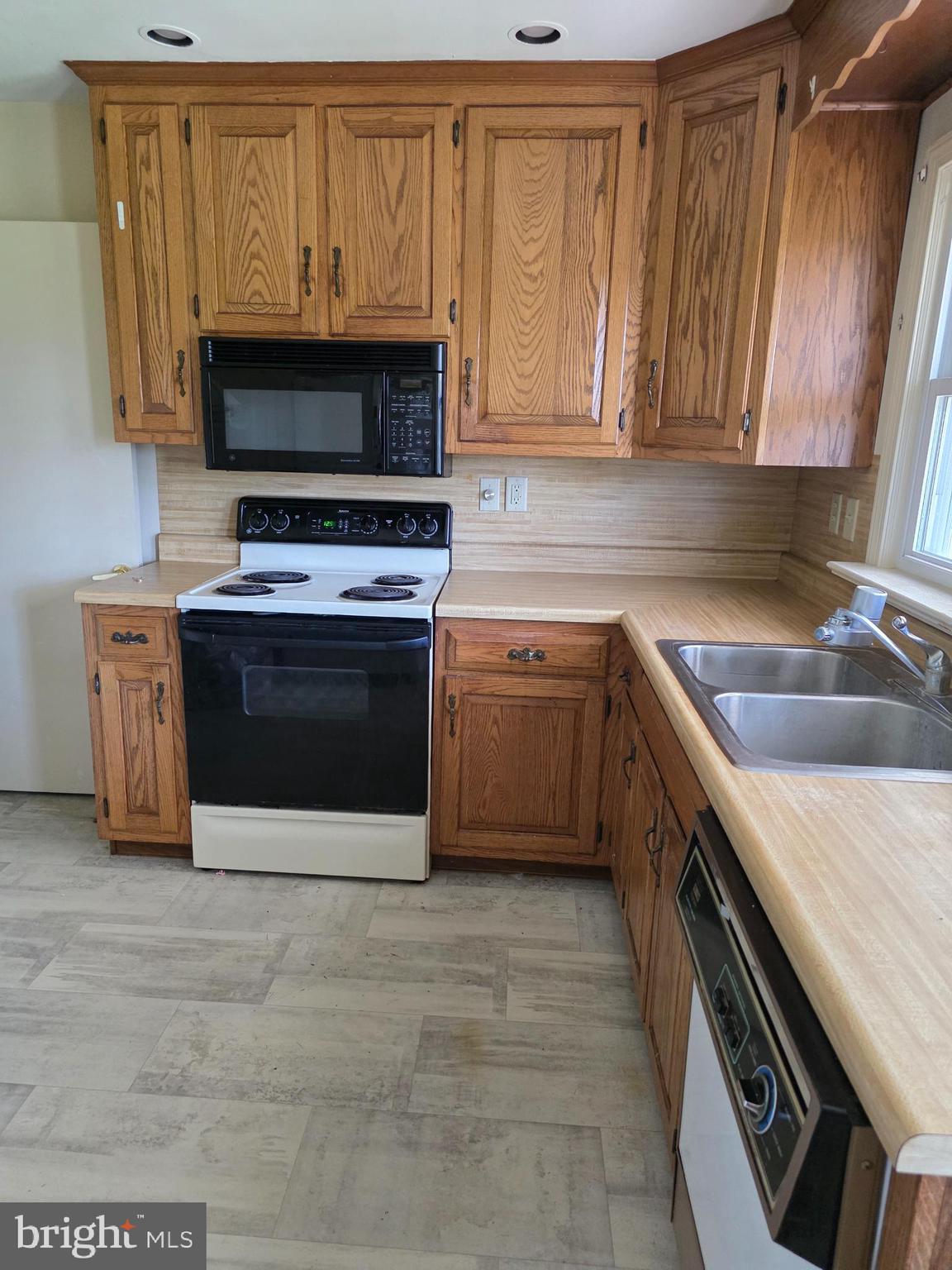 706 East Division Street Dover, DE 19901 - Photo 7 of 16 a kitchen with stainless steel appliances a stove microwave and sink