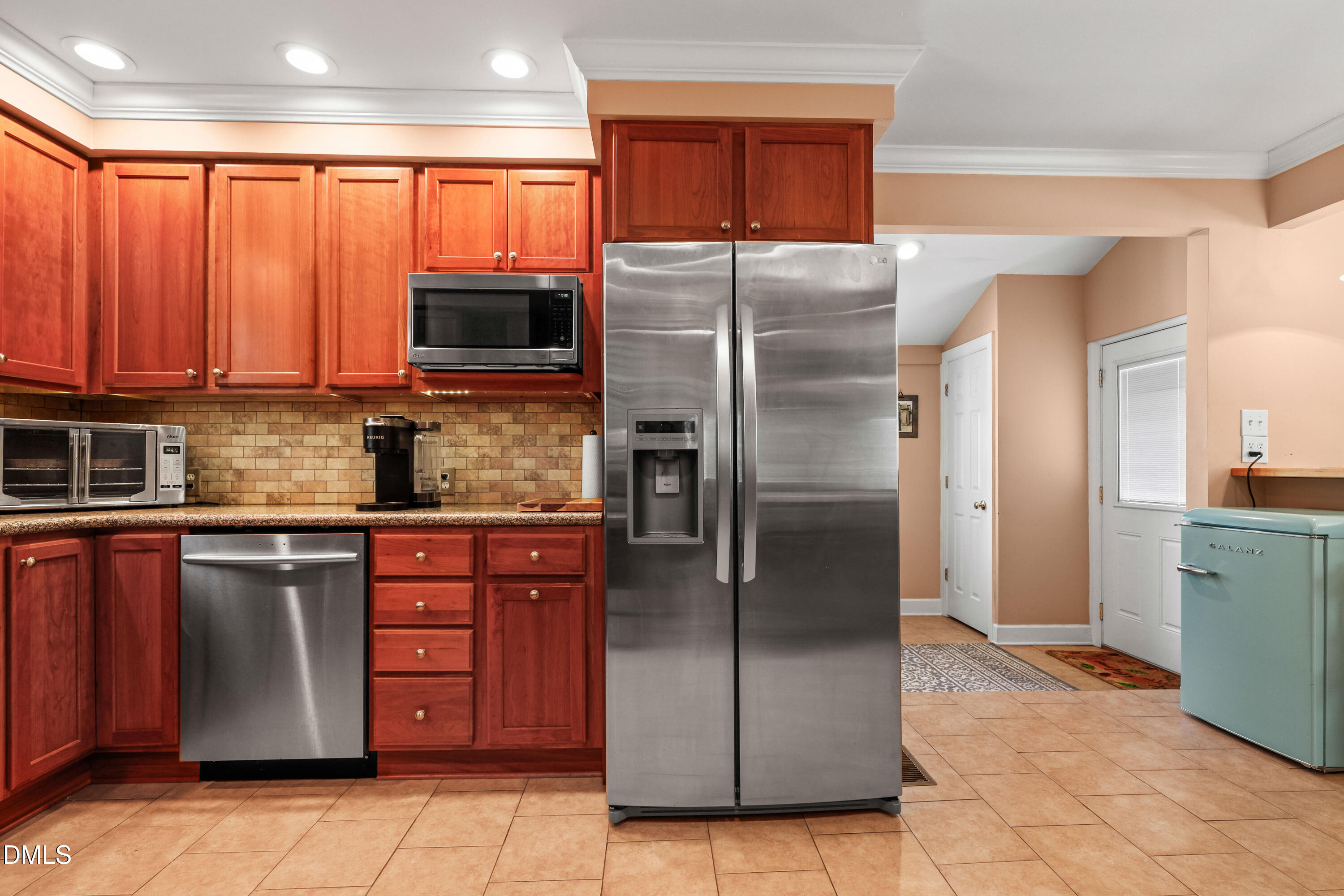 1491 Farrington Point Road Chapel Hill, NC 27517 - Photo 11 of 52 a kitchen with stainless steel appliances granite countertop a refrigerator and a stove top oven