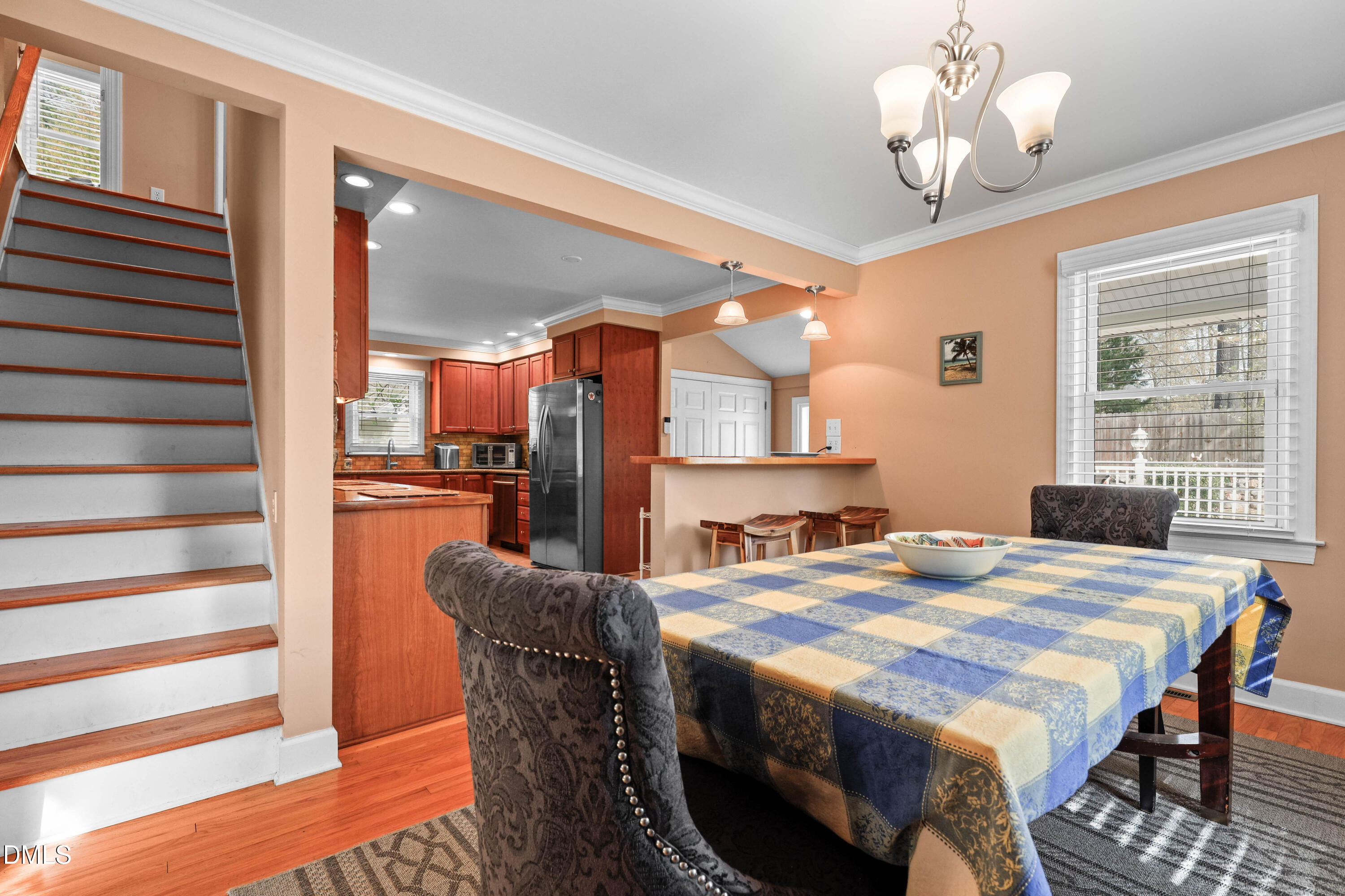 1491 Farrington Point Road Chapel Hill, NC 27517 - Photo 14 of 52 a dining room with a table chairs and a kitchen view