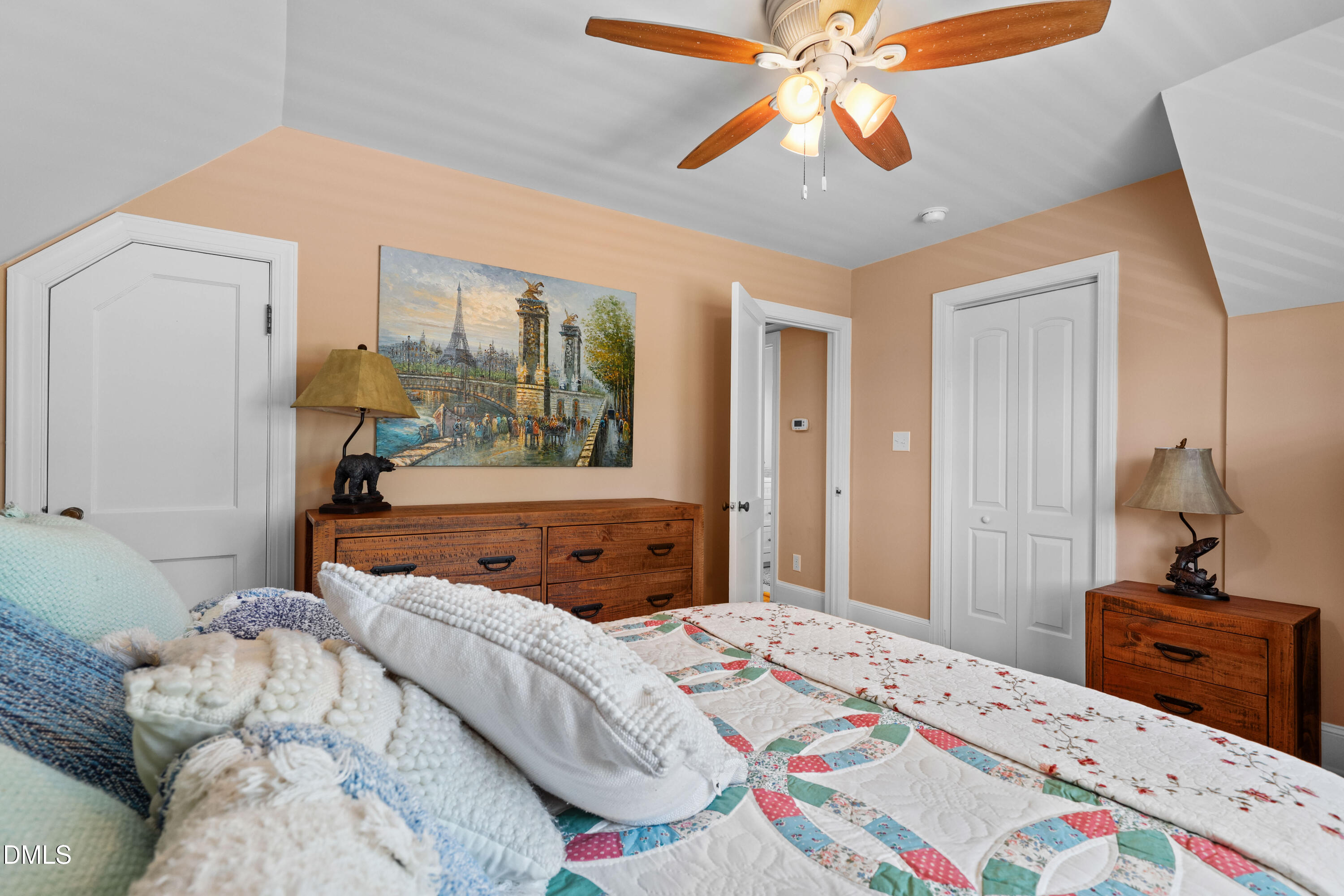 1491 Farrington Point Road Chapel Hill, NC 27517 - Photo 25 of 52 a bedroom with a bed and a chandelier