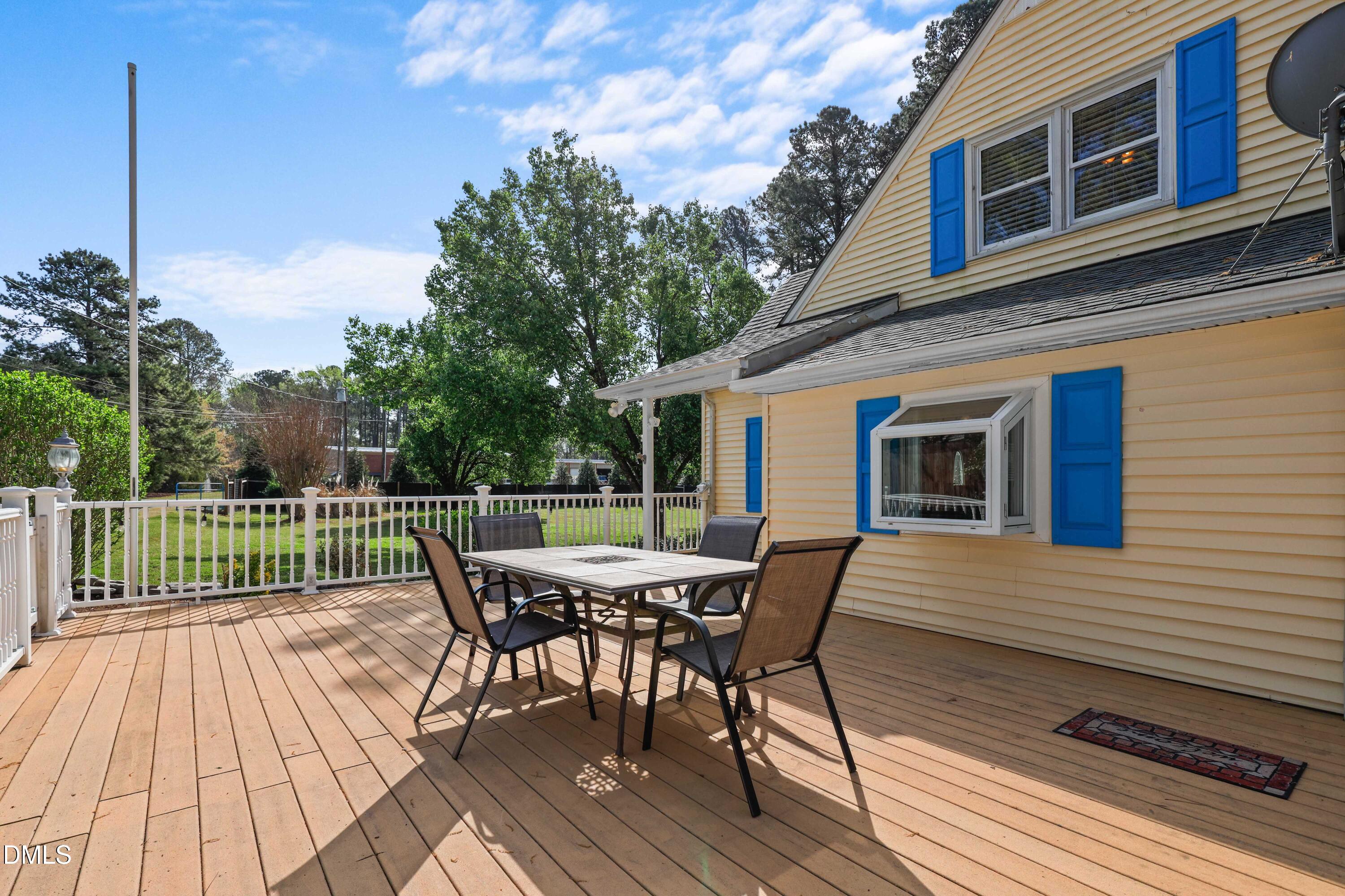 1491 Farrington Point Road Chapel Hill, NC 27517 - Photo 35 of 52 a view of a roof deck with table and chairs and wooden floor
