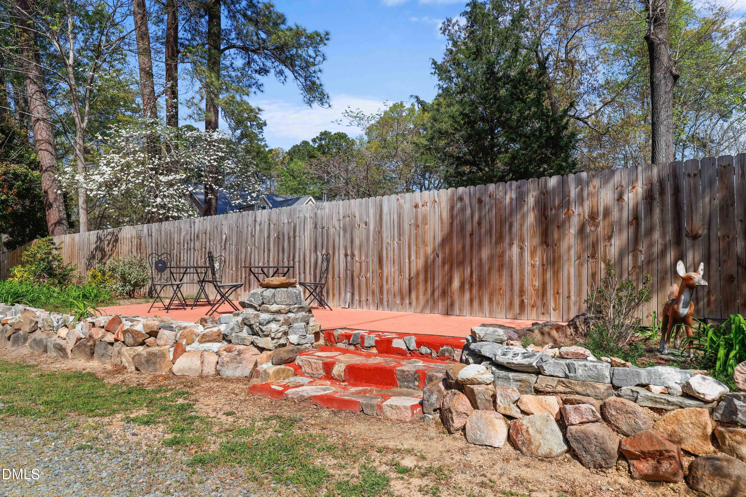 1491 Farrington Point Road Chapel Hill, NC 27517 - Photo 36 of 52 a view of backyard with a table and chairs