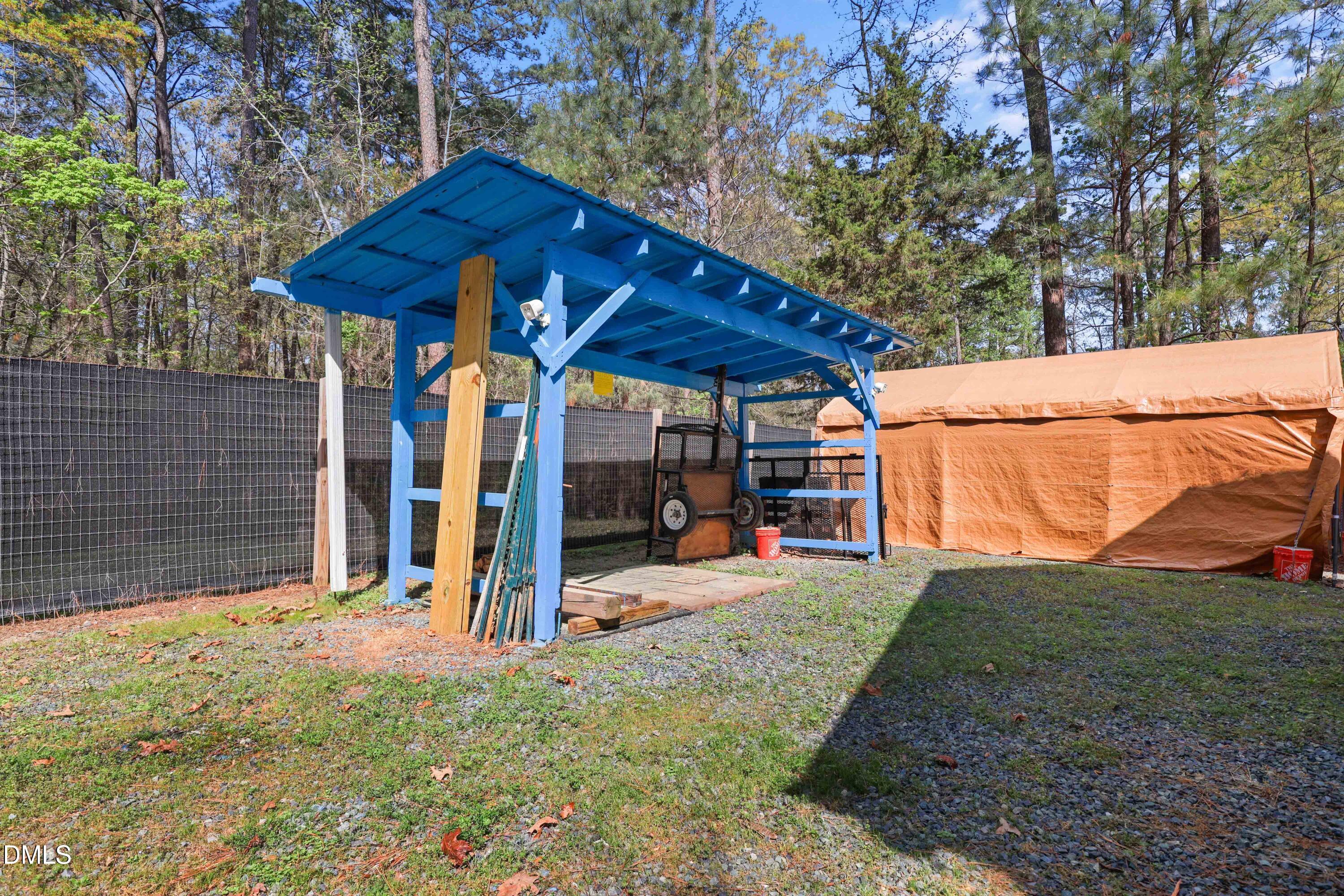 1491 Farrington Point Road Chapel Hill, NC 27517 - Photo 46 of 52 a view of a backyard with a small cabin