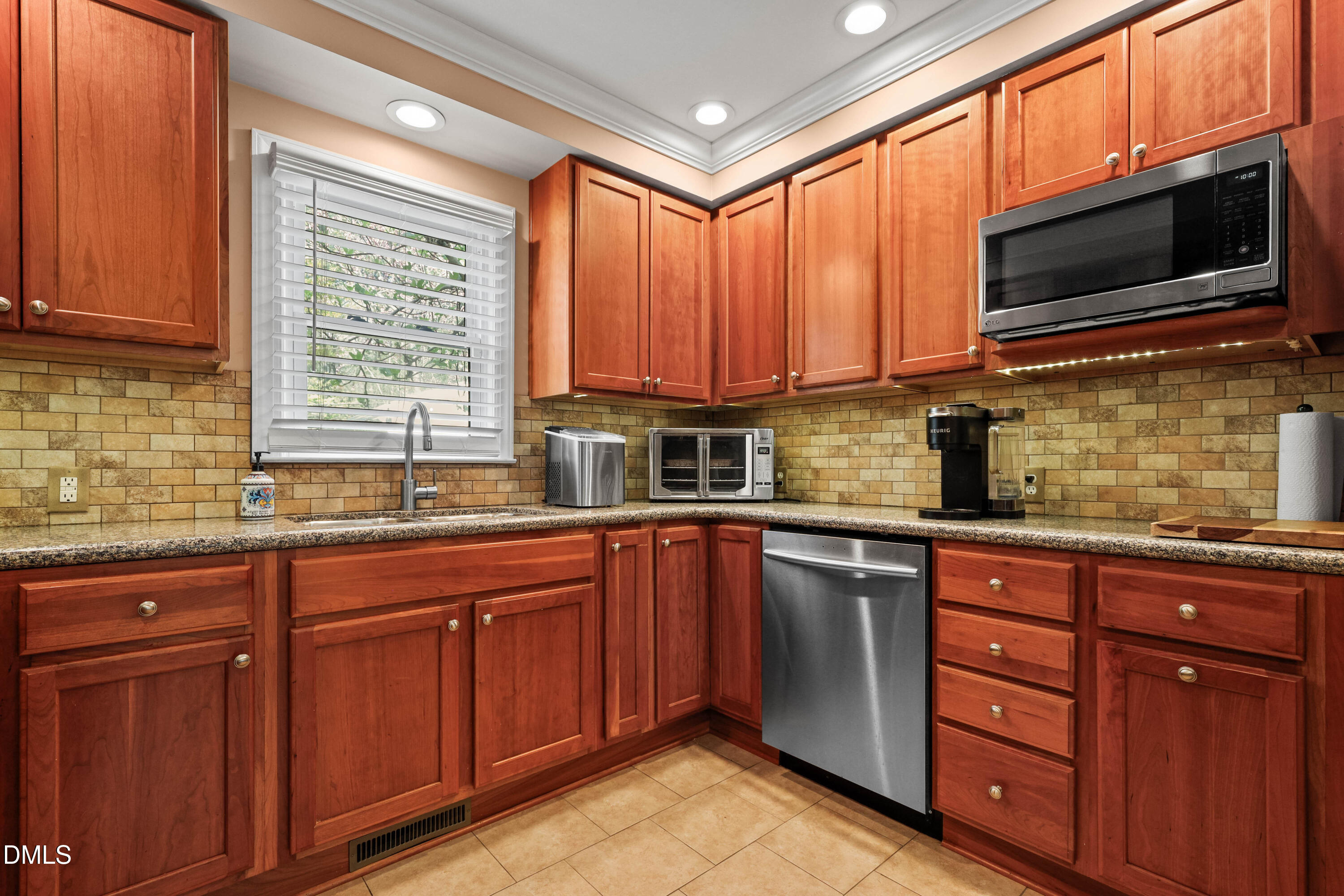 1491 Farrington Point Road Chapel Hill, NC 27517 - Photo 10 of 52 a kitchen with stainless steel appliances granite countertop wooden cabinets a sink and a window