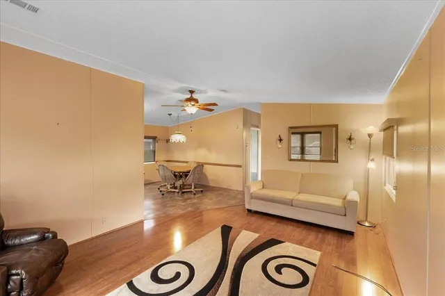 a view of living room with furniture and wooden floor