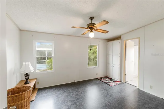 a view of room with a ceiling fan and window