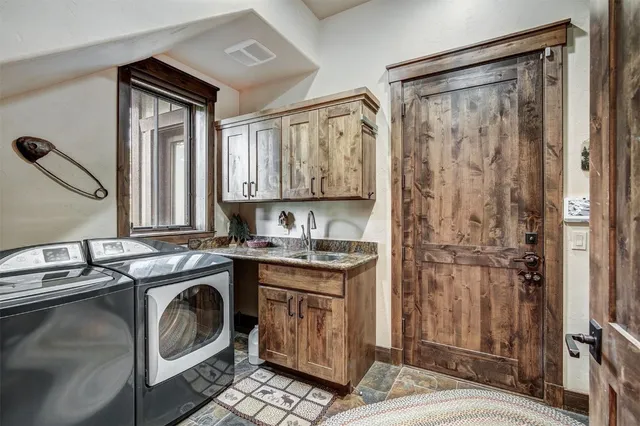 a kitchen that has a sink a washer and dryer