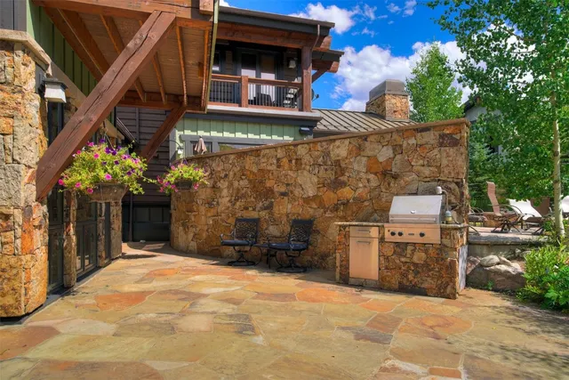 a backyard of a house with table and chairs