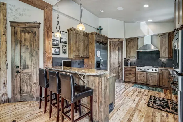 a kitchen with stainless steel appliances a sink stove and refrigerator