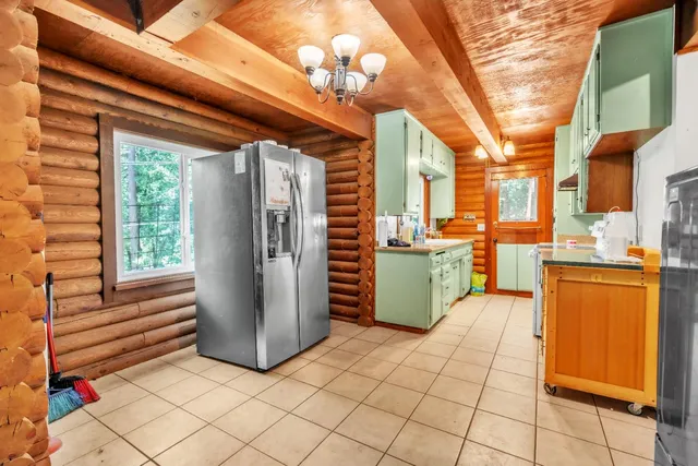 a kitchen with stainless steel appliances a refrigerator and a stove