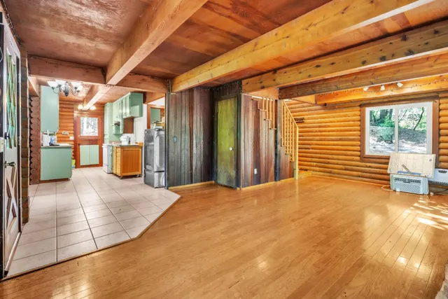 a view of a porch with a table and chairs and potted plants