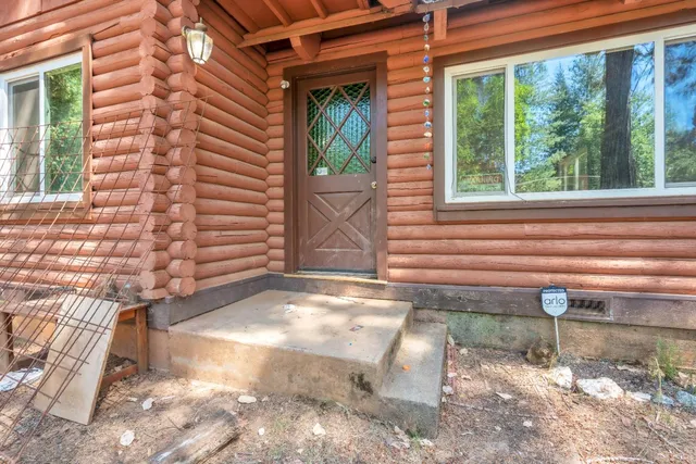 a view of a patio with table and chairs and wooden fence