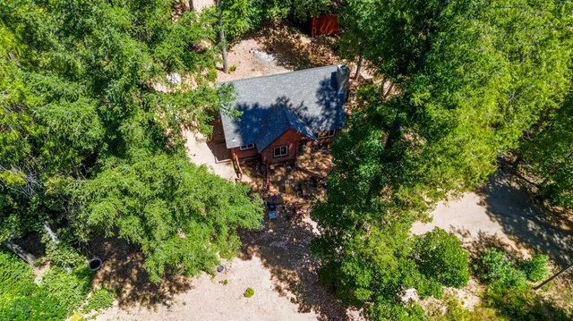 an aerial view of house with yard and outdoor seating