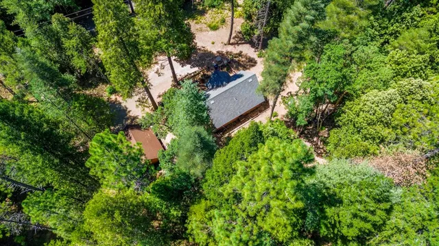 an aerial view of a house with a yard