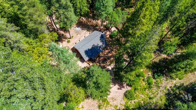 an aerial view of a house with yard