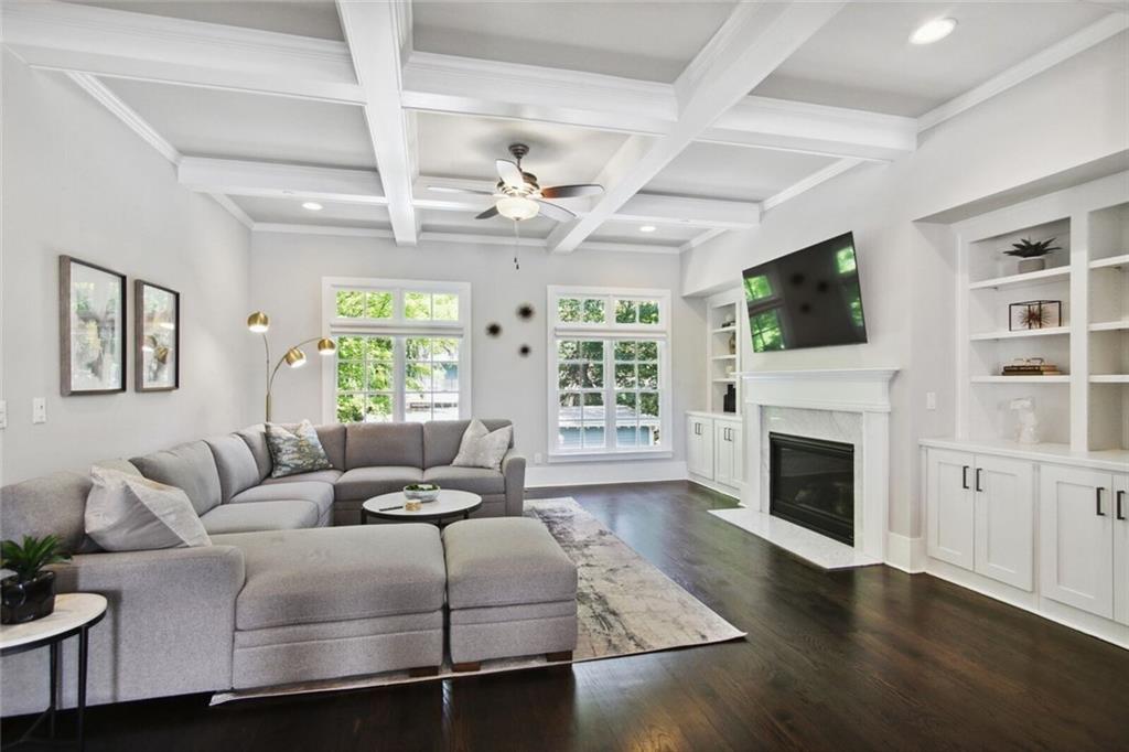 692 Drewry Street Northeast Atlanta, GA 30306 - Photo 4 of 25 a living room with furniture a flat screen tv and a fireplace