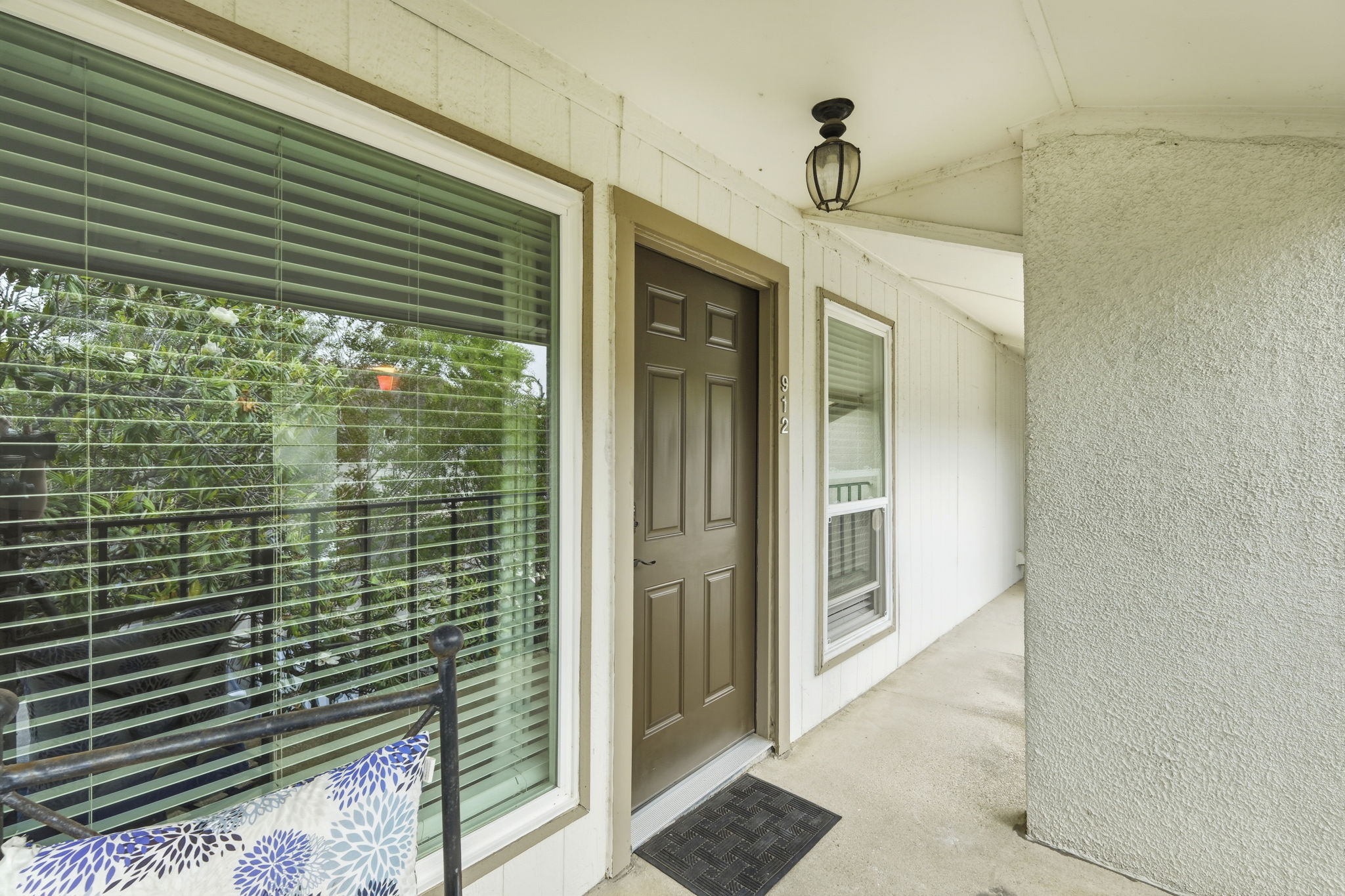 6910 Hart Lane, Unit 912 Austin, TX 78731 - Photo 21 of 36 Entryway featuring a paneled door, sidelight window, and an overhead lantern light fixture