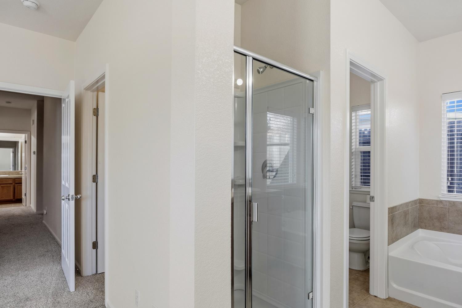 170 Par Court Ione, CA 95640 - Photo 20 of 31 a bathroom with a glass shower door and mirror