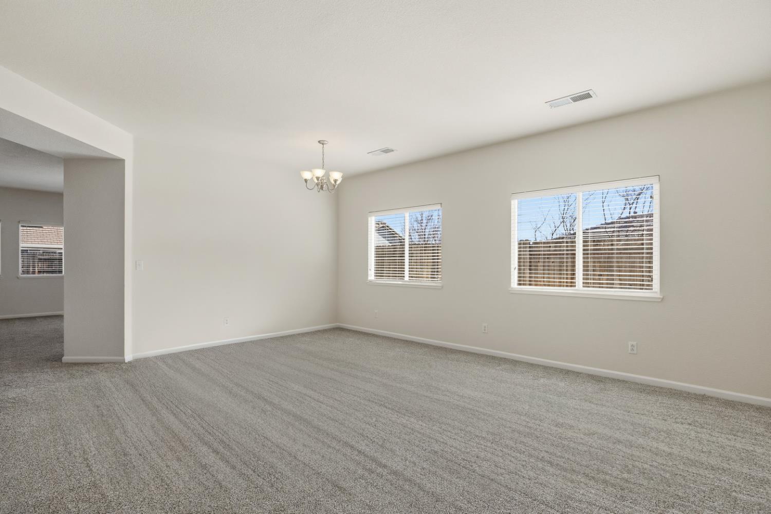 170 Par Court Ione, CA 95640 - Photo 5 of 31 a view of an empty room with wooden floor and a window
