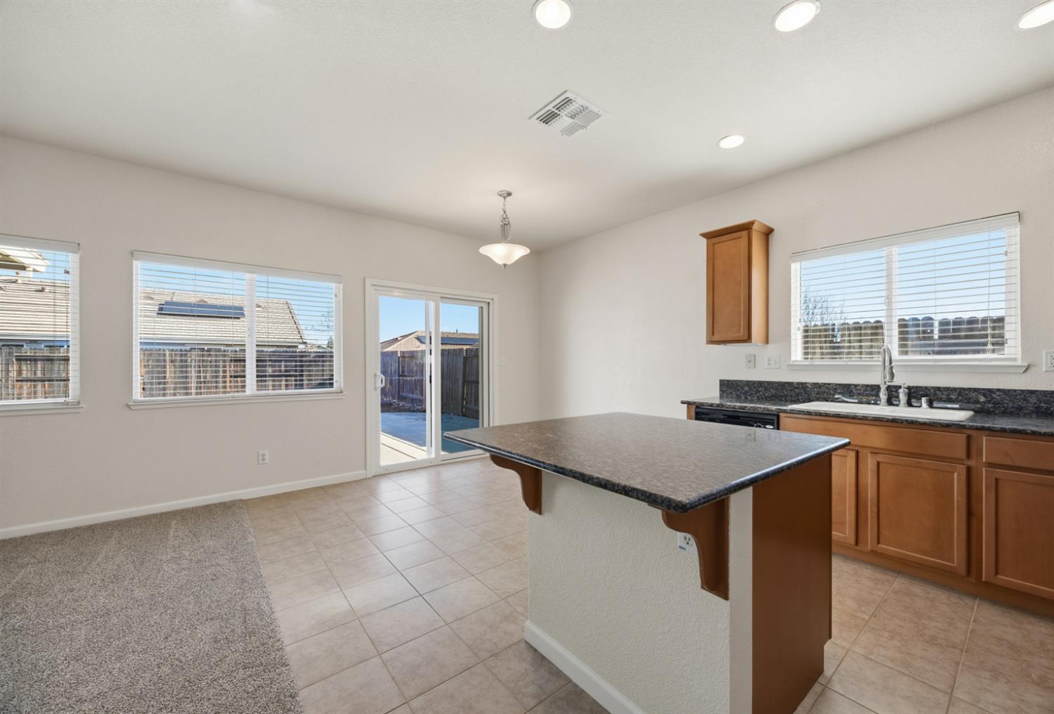 170 Par Court Ione, CA 95640 - Photo 8 of 31 a kitchen with a stove a sink a counter top space and large windows