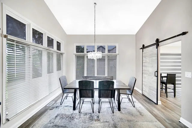 a view of a dining room with furniture window and wooden floor