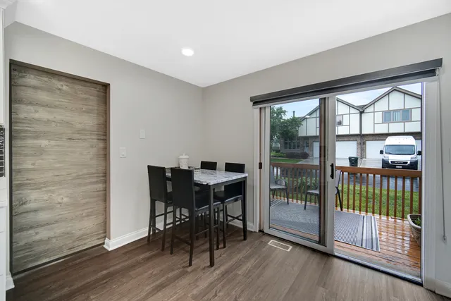 a view of a room with furniture and wooden floor