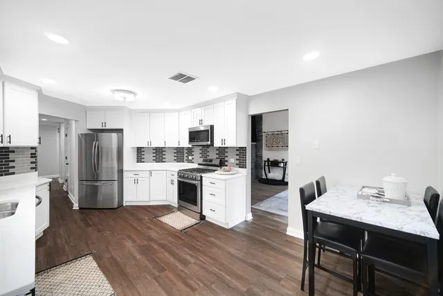 a kitchen with a refrigerator a sink and a stove
