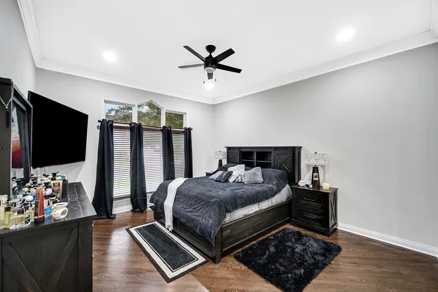 a bed room with a bed window and a flat screen tv