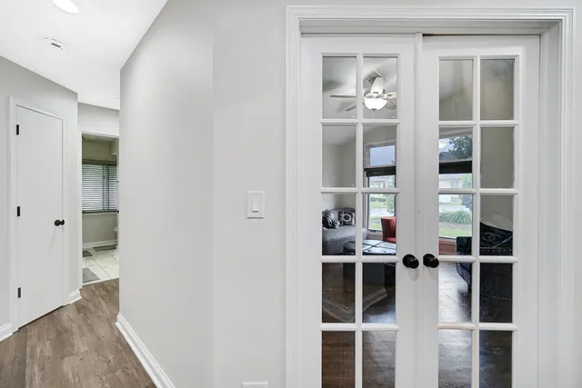 a view of a hallway with wooden floor and entryway