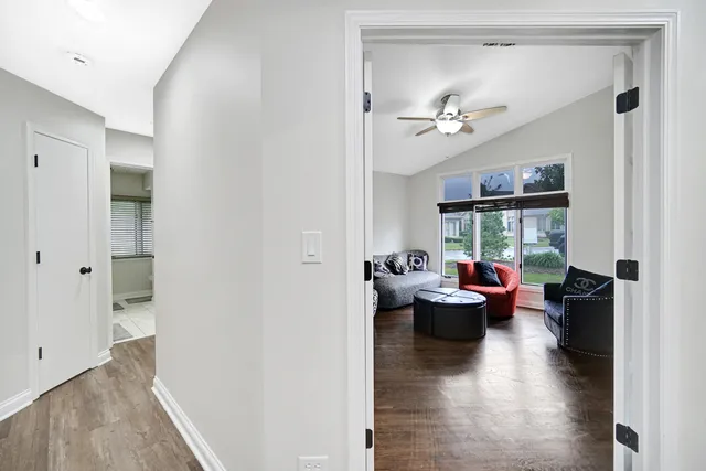 a living room with furniture a fireplace and a chandelier